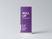 Purple roller banner with a sample design standing upright on its base against a plain grey background