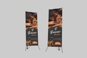 Two X-frame banners of different heights with a sample food design on black stands against a grey background