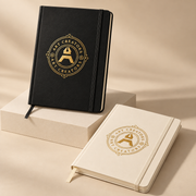 Black and cream Spectrum A5 notebooks with elastic bands and a gold Art Creators logo on the cover