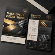 Black special material flyers with a gold and black Art Creators sample design on a dark surface
