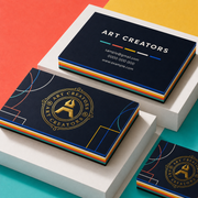 Navy multi layer business cards with colourful striped edges and a gold Art Creators logo