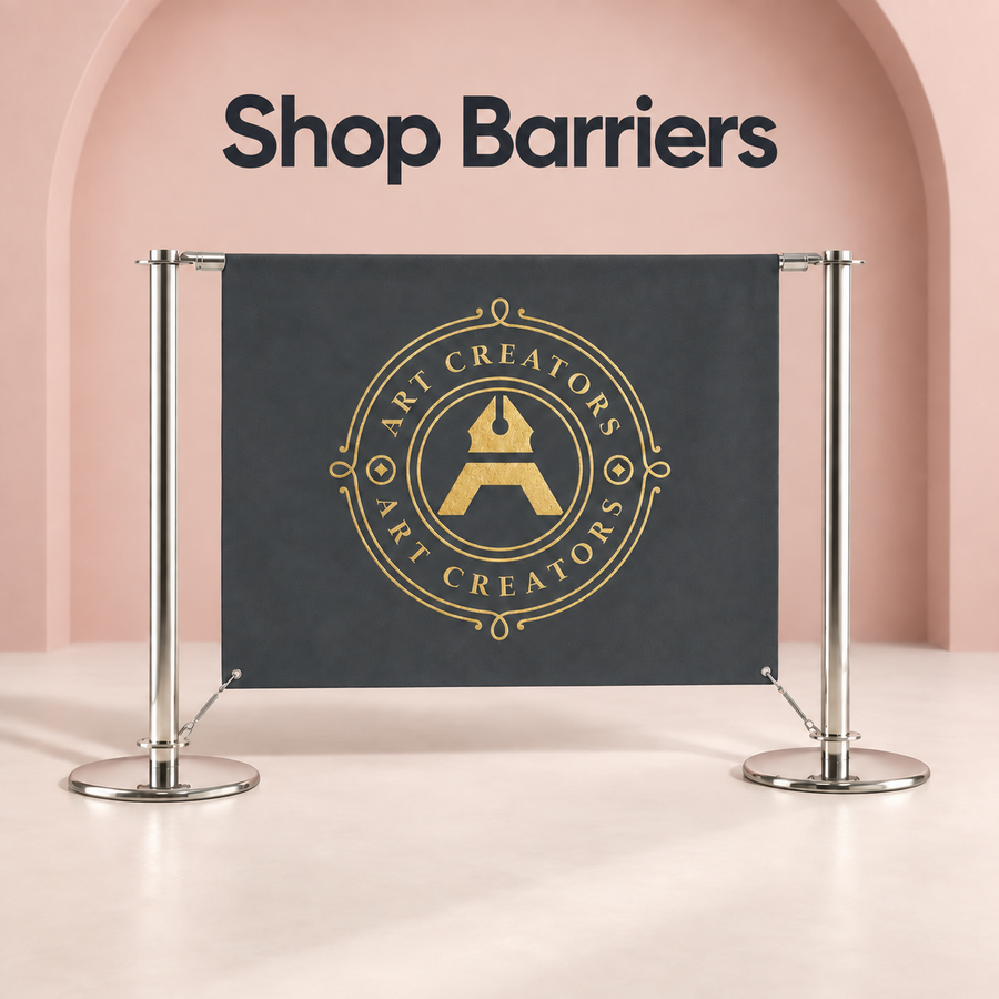 Shop barrier with a charcoal banner showing the gold Art Creators logo between two chrome posts by a pink wall